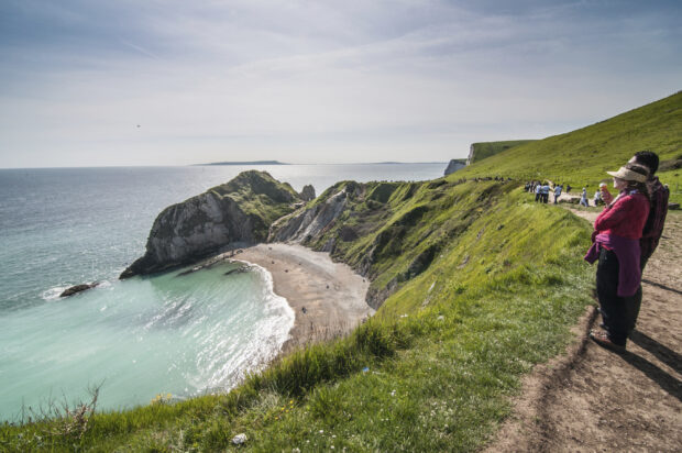 Tourist enjoying beautiful scenery at the Jurassic Coast, Dorset,