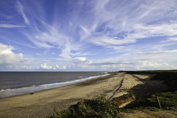 Stretch of coastline and blue sky.