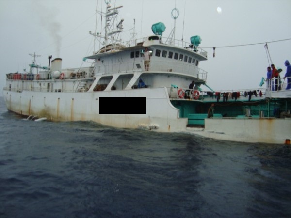 Picture of a large white fishing boat out at sea.