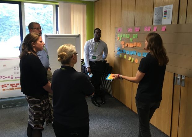 5 individuals discuss improvements at a workshop