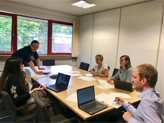 Colleagues sitting around a desk